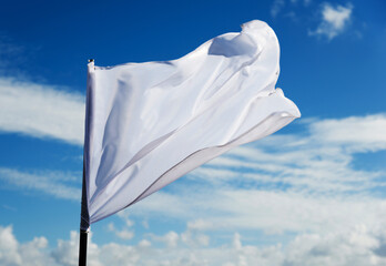 White flag flying against blue sky