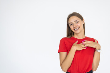 Happy woman laughing and smiling carefree, touching chest while chuckling over funny joke, standing on white background.