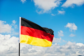 German flag waving against blue sky