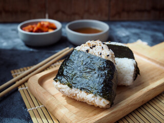 Onigiri Japanese traditional food, steamed rice in triangle shape wrap with seaweed.