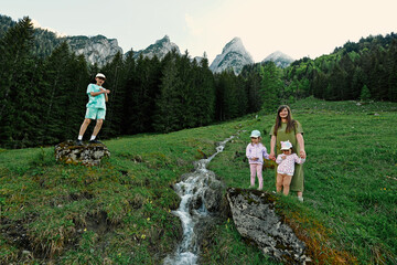 Mother with children near mountain clean water source at Vorderer Gosausee, Gosau, Upper Austria.