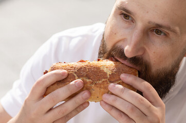 Young Hipster Male In Pub Eating Delicious Burger.