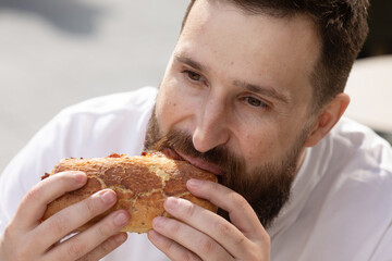 Young Hipster Male In Pub Eating Delicious Burger. 