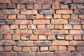 Red old worn brick wall background. Vintage effect. Abstract pattern of bricks. Grunge concrete backdrop. Brown cement texture. Construction material for decoration design, architecture, rough surface