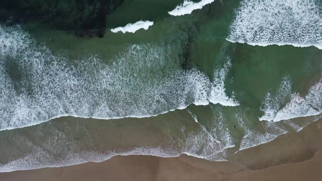 The waves on the beach of La Palue in Brittany in France, filmed with the drone from above
