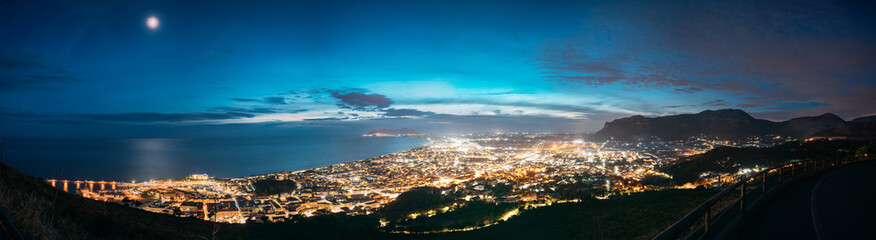 Terracina, Italy. Top View Skyline Cityscape City In Evening Night Illuminations. Panorama, Panoramic View.