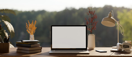 Home working space with laptop mockup and decor on table over the window with mountain view