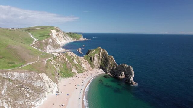 The drone aerial footage of Durdle Door and St Oswald's Bay beach, Dorset. Durdle Door is a natural limestone arch on the Jurassic Coast near Lulworth in Dorset, England.