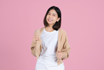 Fototapeta premium Cute asian woman in casual clothes. She is holding a shirt and dancing.