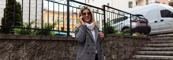 mature woman walking around the city talking on a mobile phone, freelance work concept