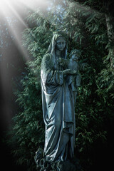Ancient statue of the Virgin Mary with the baby Jesus Christ. Vertical image.