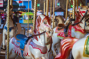 Fototapeta na wymiar Carousel or merry-go-round at Christmas funfair winter wonderland in London