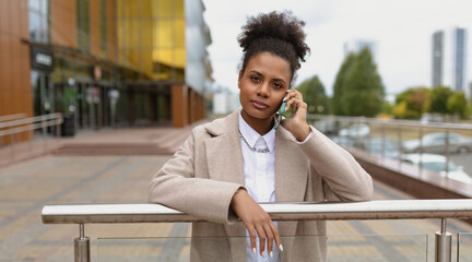 serious young american woman lawyer talking on mobile phone, concept of a strong successful woman