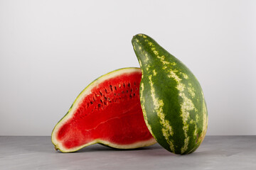 Halved cut of pear-shaped watermelon. Deformed ugly watermelon. Selective focus. Concept - Food...