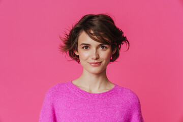 Fototapeta premium Young white woman wearing sweater smiling and looking at camera