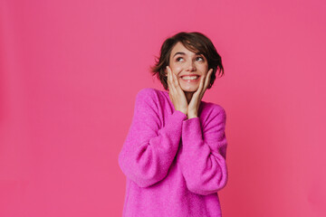 Young white woman wearing sweater smiling and looking upward