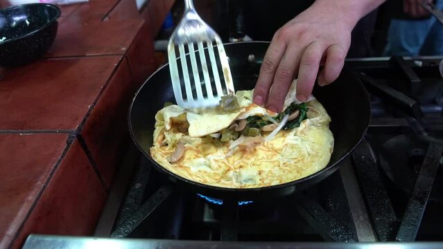 egg omelette with ham, spinach, onion and more, ready to serve