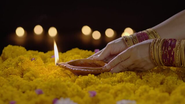 Clay diya lamps lit during diwali celebration.