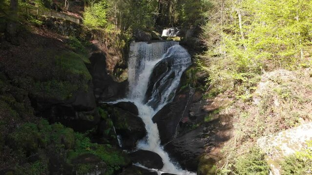 Water running from the Triberg waterfall, located in the Black Forest (Germany) in middle of the green mountain during summer sunny day