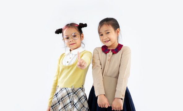 Junior asian schoolgirl posing on white background. Back to school primary student concept.