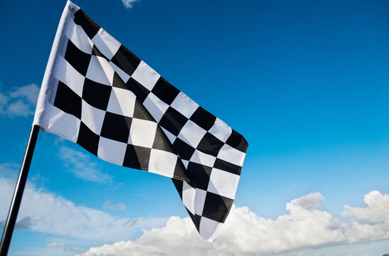 Checkered flag on blue sky
