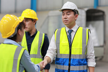 Group of technician engineer and businessman in protective uniform standing and discussing, researching, brainstorming and planning work together with protection mask at industry manufacturing factory