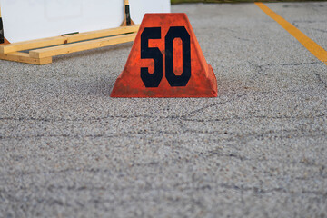 orange fifty yard line marker ready for a marching band rehearsal