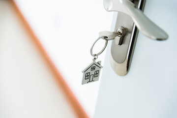 Key with house shaped keyring on door