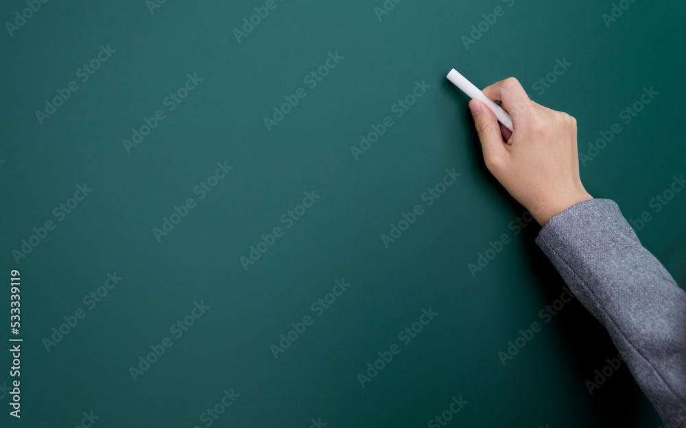 Wall mural businesswoman hand writing chalk on blackboard