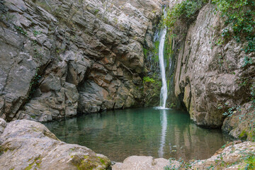 Fototapeta na wymiar Small pool between rocks caused by a unique waterfall.