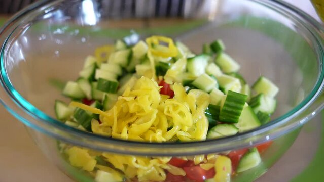 Adding Pickled Pepperoncini To A Bowl Of Chopped Salad Ingredients - ANTIPASTO SALAD SERIES