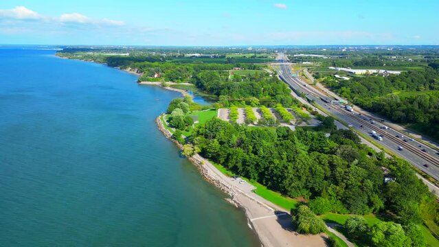 Aerial over Lake Ontario and Charles Daley Park next to QEW highway, Ontario