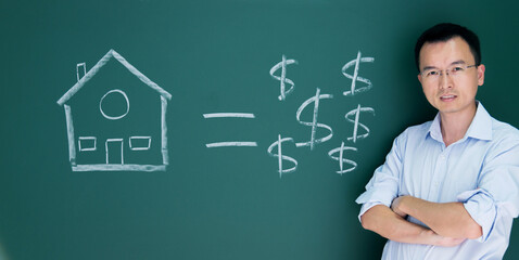 Man in front of drawing house and money on blackboard