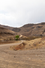 mountain gravel road pass in Lesotho winter dry season out of focus with grain