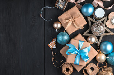 Christmas decorations and gifts on a black background. The concept of Christmas, New Year. Top view, copy space