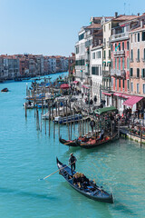 Fototapeta na wymiar Gandolas and small boats in Venice's inner canal. Italy, 2019
