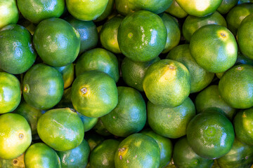 Tangerines on the market counter. Pile of ripe tangerines