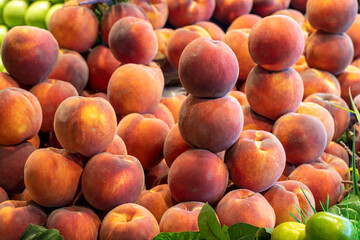 Peach on the market counter. Pile of ripe peaches