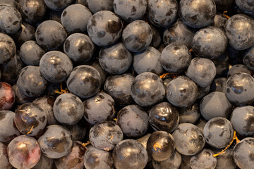 Bunch of grapes on the market counter. Pile of ripe grapes