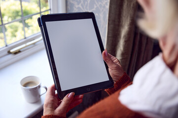 Senior Woman With Digital Tablet Looking At Online Energy Bill In Cost Of Living Energy Crisis