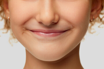 Cropped image of little girl face. Macro, close up parts of face. Chin, nose and mouth