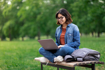 Online Learning. Young Arab Woman With Laptop Sitting On Bench In Park