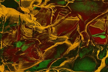 Multiple areas filled with golden dust on Alcohol ink fluid abstract texture fluid art with gold glitter and liquid.