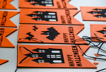 Black and orange party flags for Halloween decoration. Festive Halloween decor in the form of black and orange flags with symbols, preparation for the holiday. Holidays, decoration and party concept