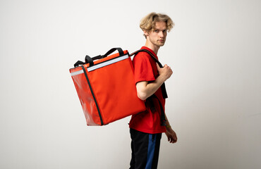 Side view courier guy in red uniform with a thermo blackpack on white background.