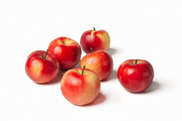 Organic red-yellow small apples on a white isolated background