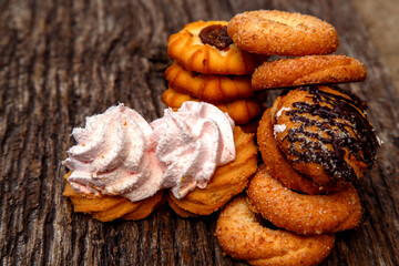 Fresh homemade biscuits in stock. Sweet cookies on a wooden table. Dessert sweet biscuits for tea and coffee. Concept of yummy, cookies, desserts.
