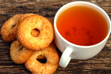 Homemade sweet cookies with tea. Delicious sweet cookies with tea on the table. Dessert cookies with tea in a cafe. The concept of desserts, sweets, coffee shop.