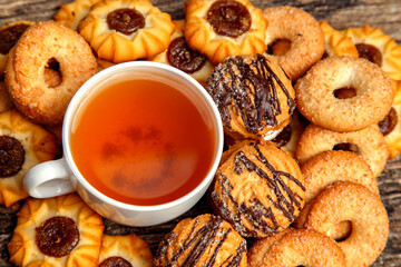 Homemade sweet cookies with tea. Delicious sweet cookies with tea on the table. Dessert cookies with tea in a cafe. The concept of desserts, sweets, coffee shop.