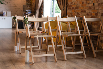 rows of empty wooden chairs